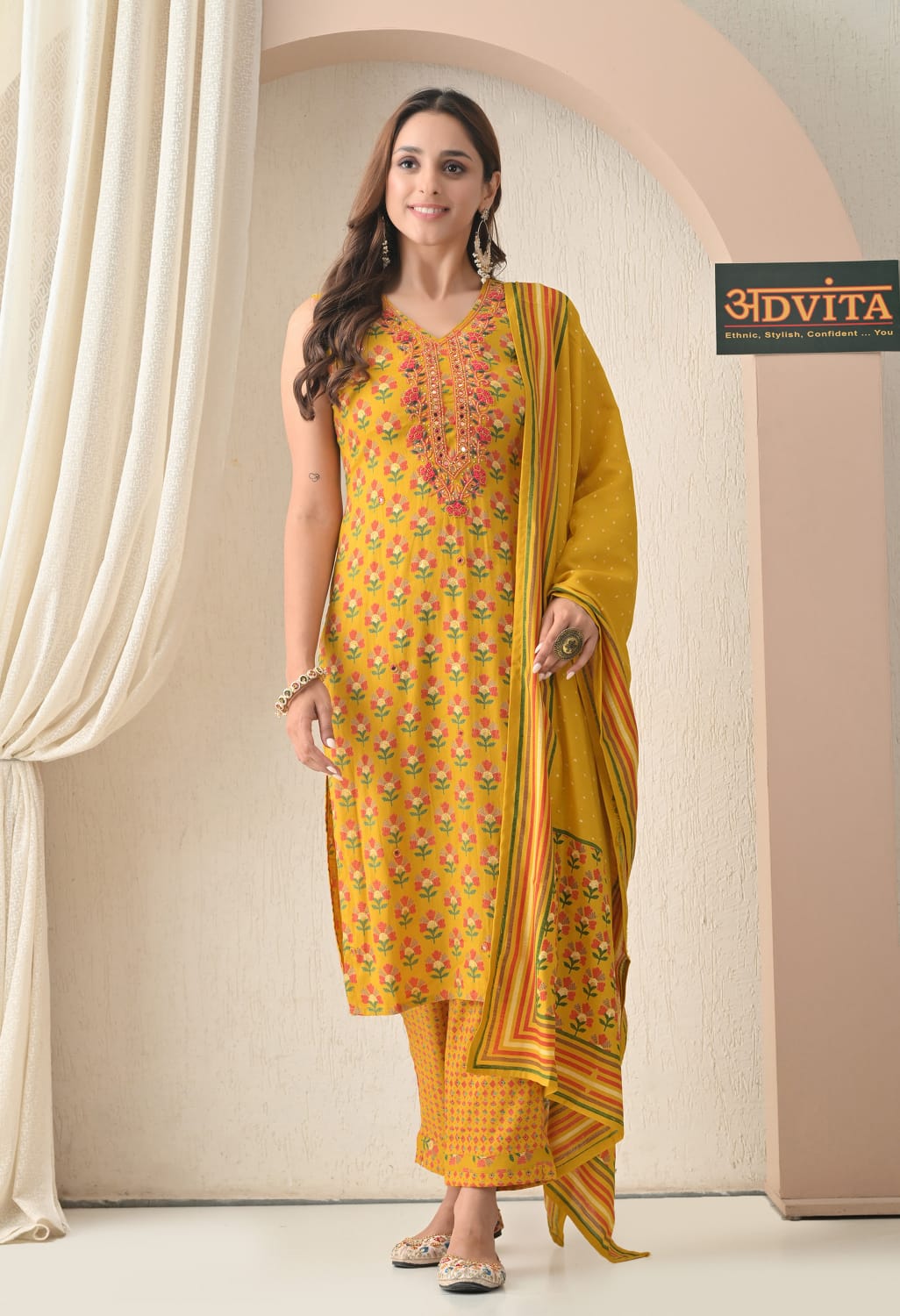 Woman wearing mustard yellow kurti pant dupatta set