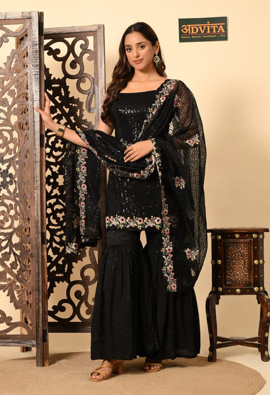 Woman wearing black sharara suit with dupatta